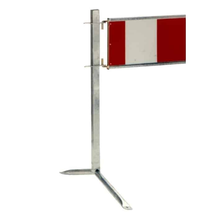 Metal barrier with a red-and-white striped panel mounted on a tall metal post used to block passage.