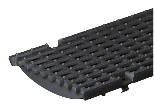 Black plastic drainage grate with a curved end and evenly spaced rectangular slots.
