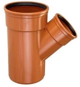Orange PVC pipe fitting with a side-entry elbow (Y-branch) for plumbing applications