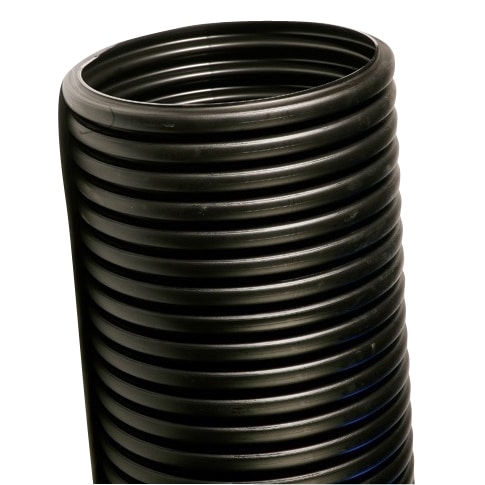 Close-up of a black, ribbed plastic drainage pipe standing upright.