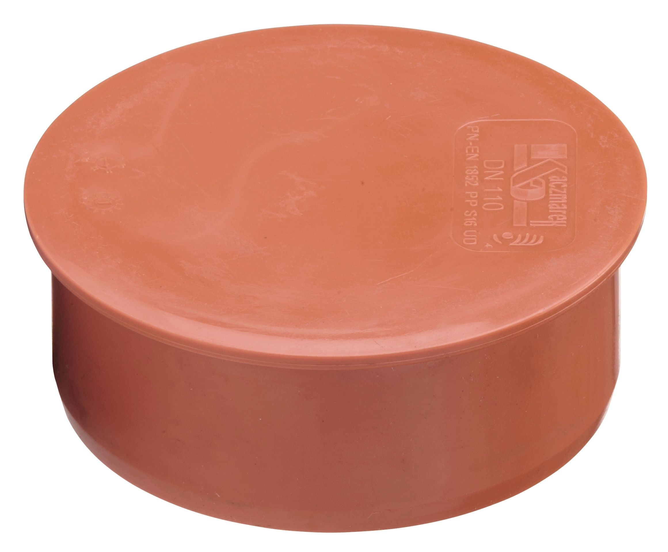 Close-up of an orange plastic lid viewed from above with embossed markings on the right side of the lid.