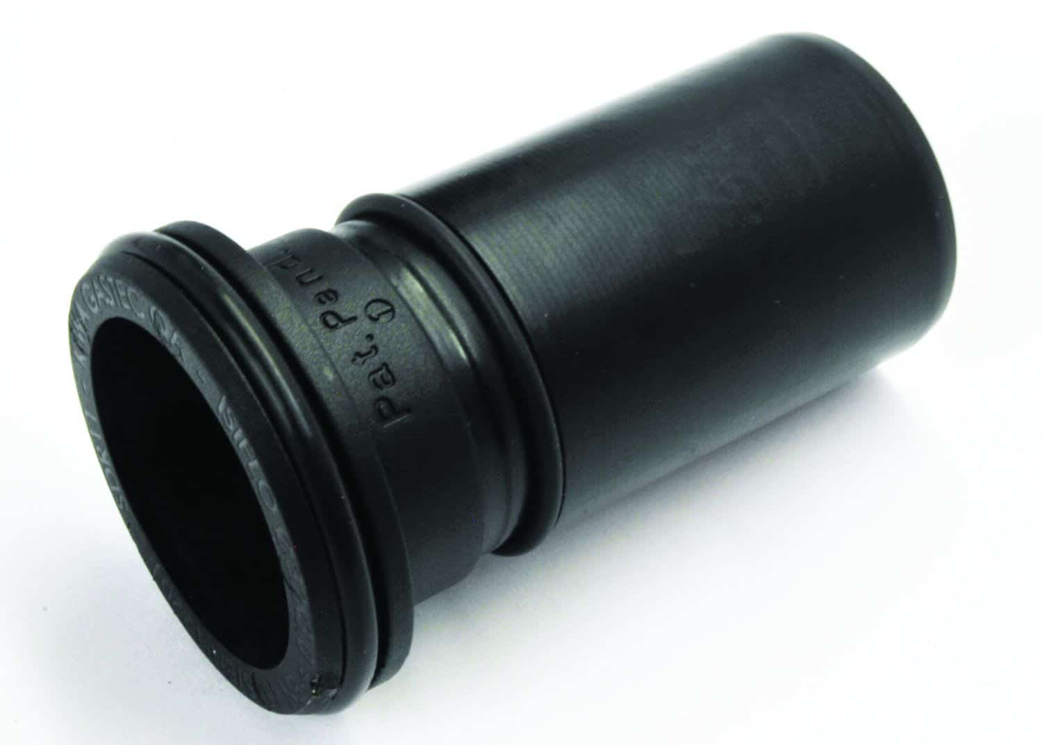 Black cylindrical camera lens extension tube lying on a white surface, showing its rear mount and threaded end
