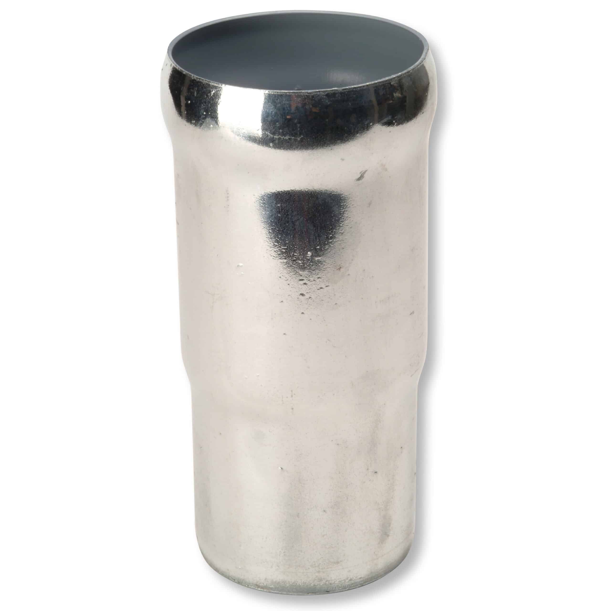 Close-up of a shiny, dented silver metal cup seen from the top, showing a dark interior