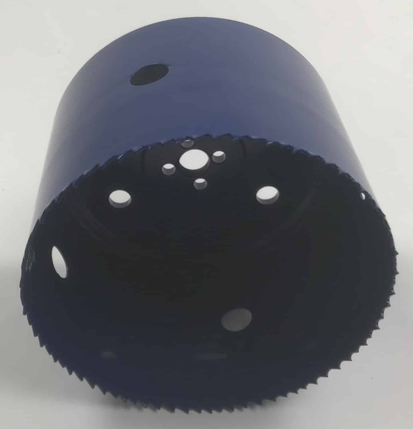 Blue cylindrical plastic object with a perforated bottom rim and several circular holes visible inside.