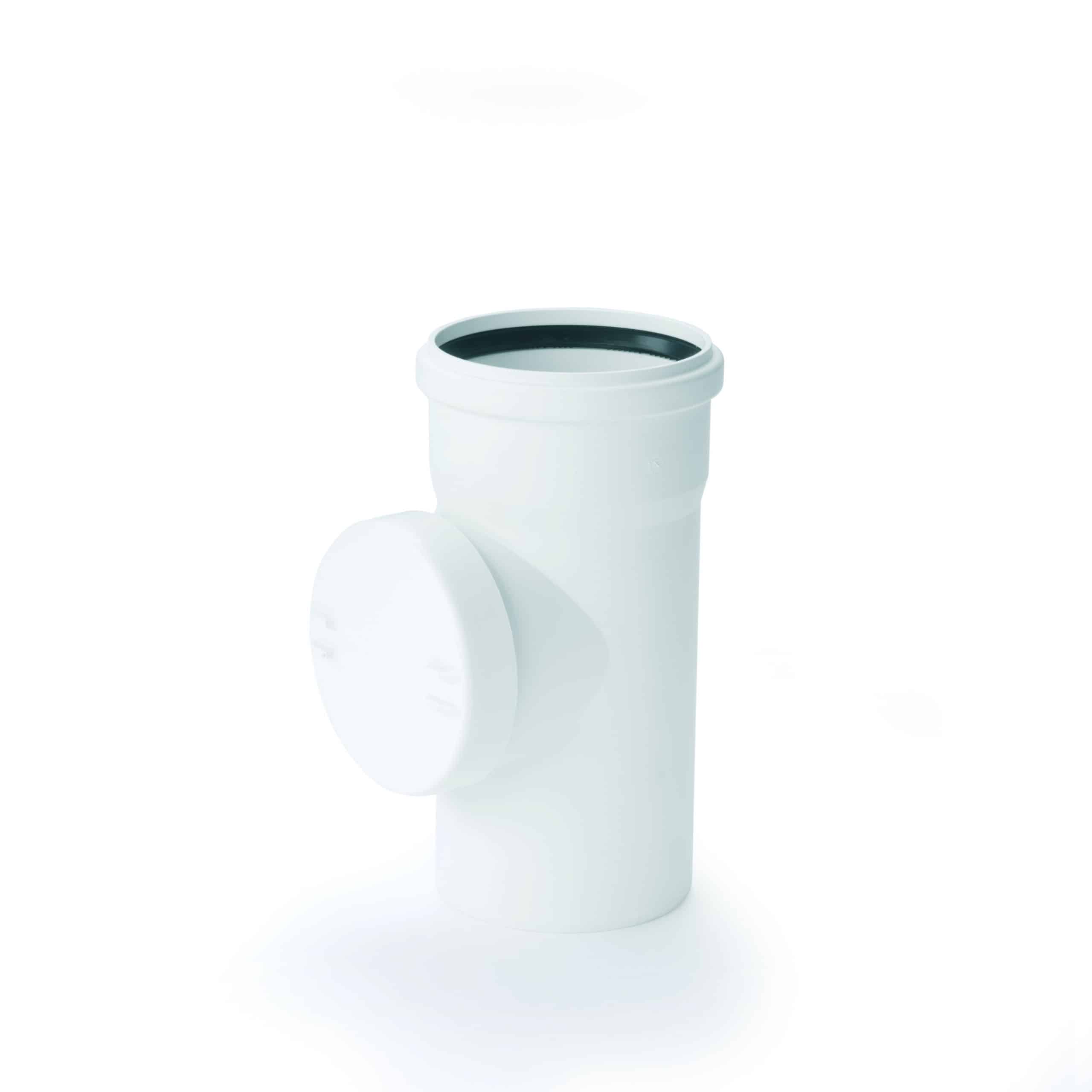 Close-up of a white PVC pipe with its cap removed and resting nearby