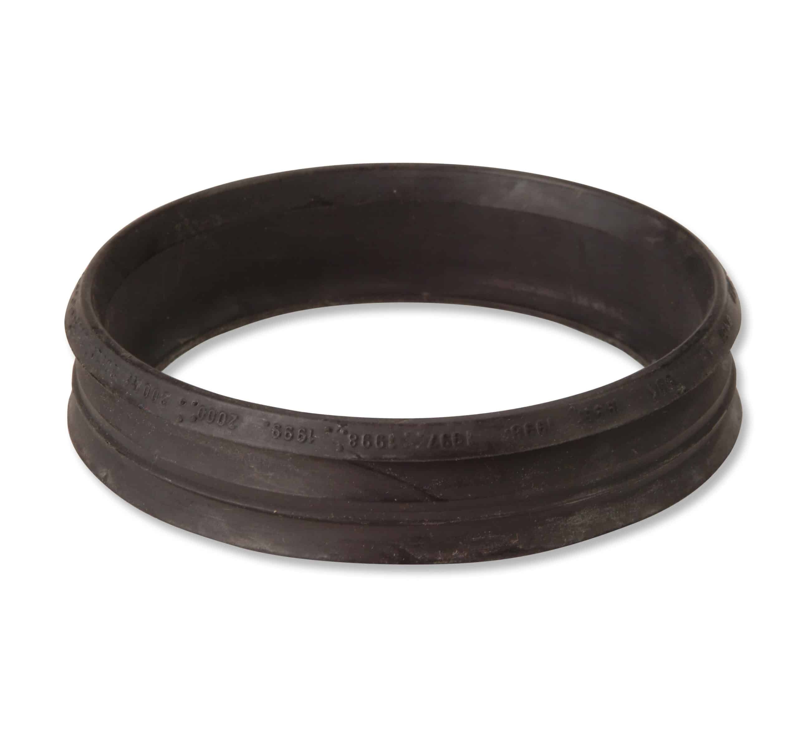 Close-up of a black rubber circular gasket with embossed markings along the rim.