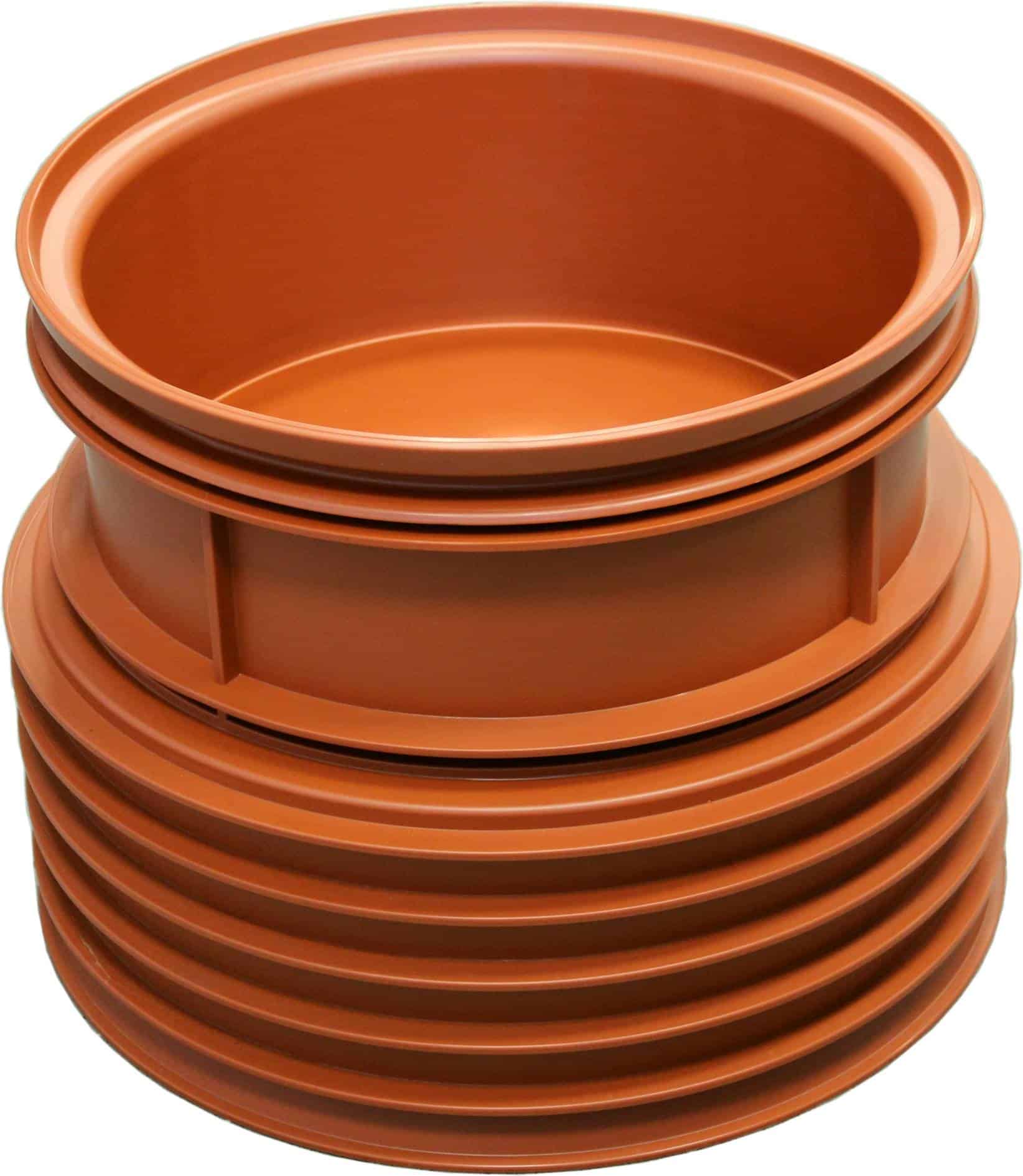 Stacked orange plastic pipes (circular cross-sections) forming a tall coil/stacked tubes.