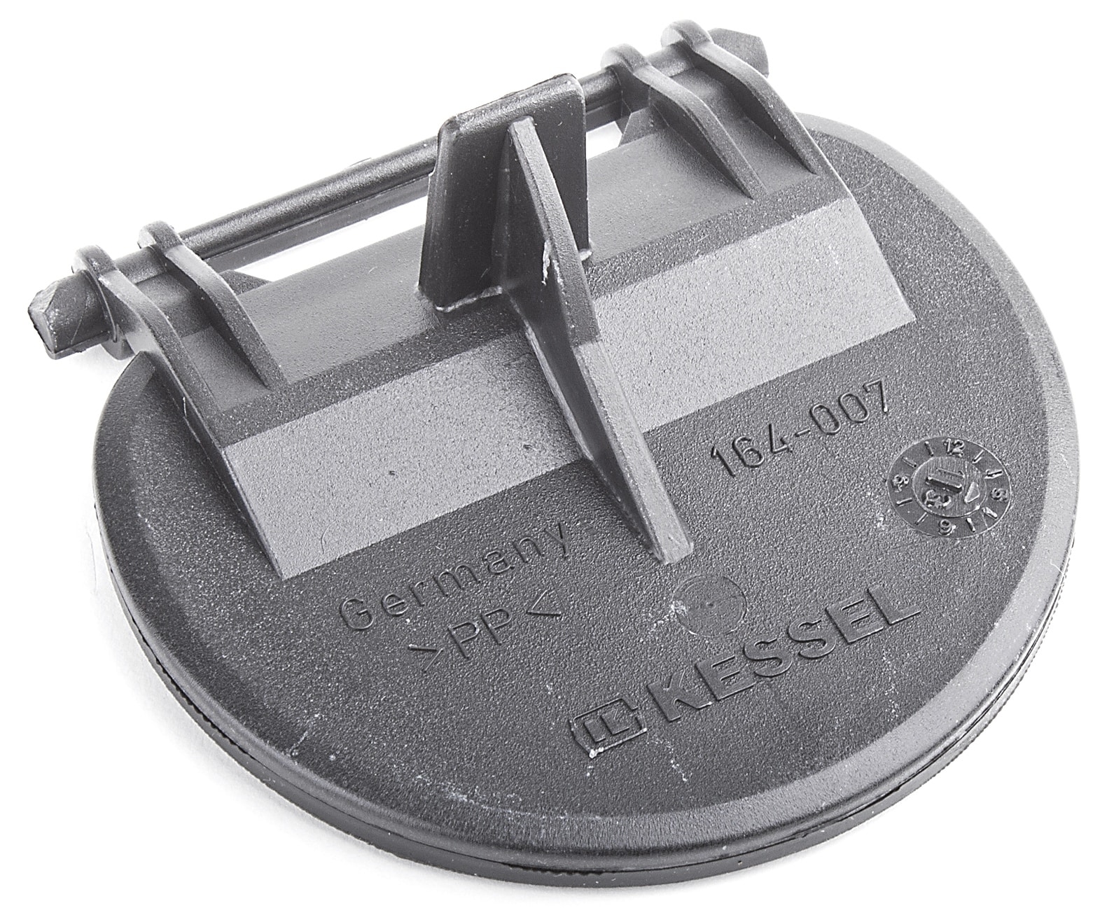Close-up of a round black plastic bottle cap with a locking tab and molded markings like 'Germany' and 'PP' on the surface.