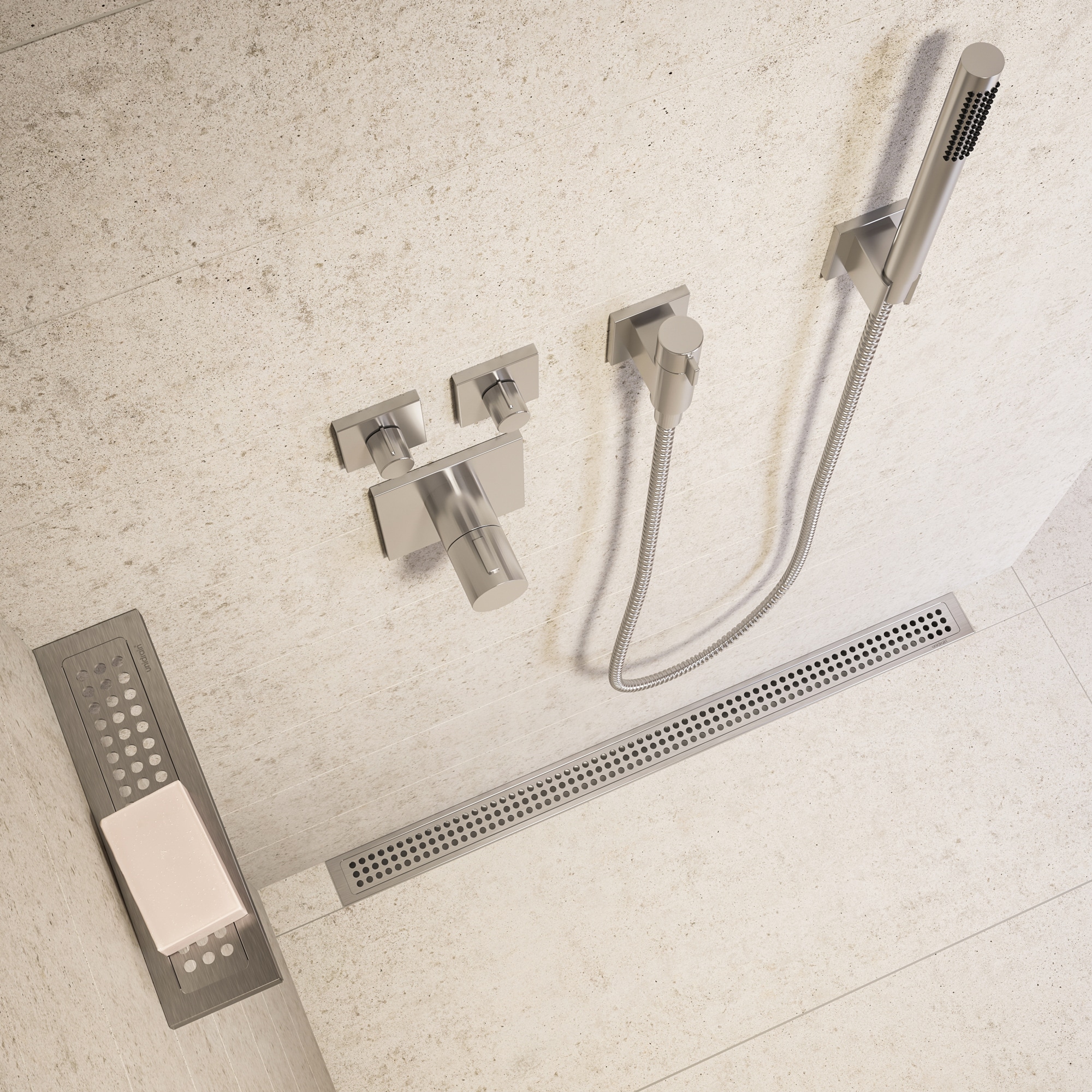 Modern shower wall with chrome handheld shower and square control knobs on beige tile