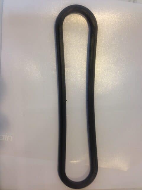 Long black rubber loop laid flat on a white surface in a vertical orientation