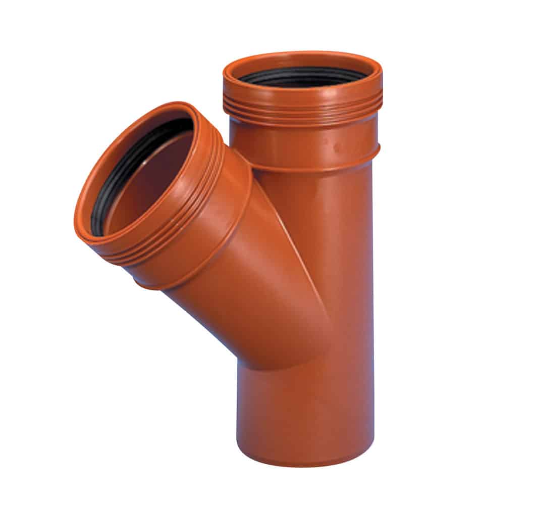 Orange PVC wye plumbing fitting with angled branch and threaded ends