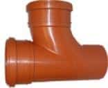 Orange PVC T-fitting with three openings for joining pipes (plastic plumbing connector). It’s orange and used for three-way connections in a pipe system.