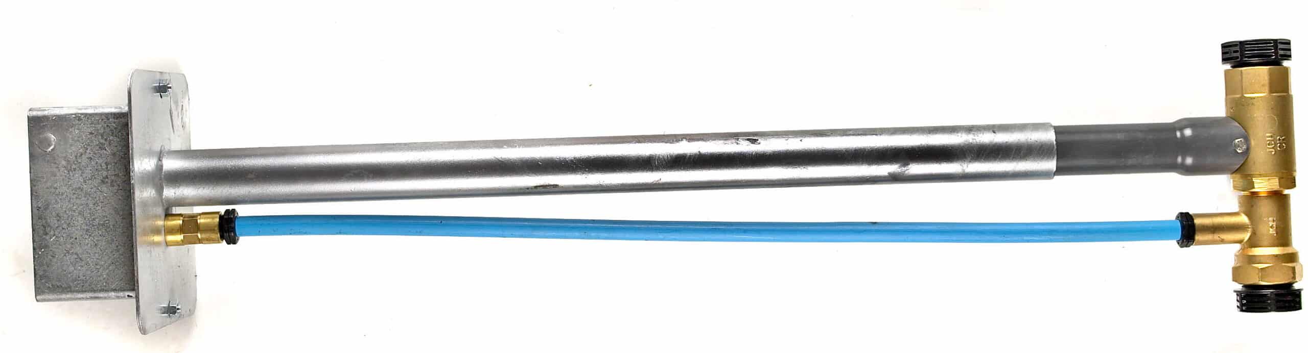 Industrial pipe and hose assembly: blue flexible line connected to brass fittings and metal tubing mounted on a metal plate