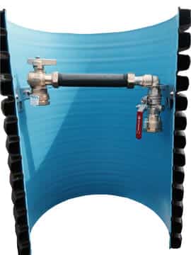 Blue curved tank with a horizontal hose-connected valve assembly and two metal valves on each end, forming a test rig inside the tank.