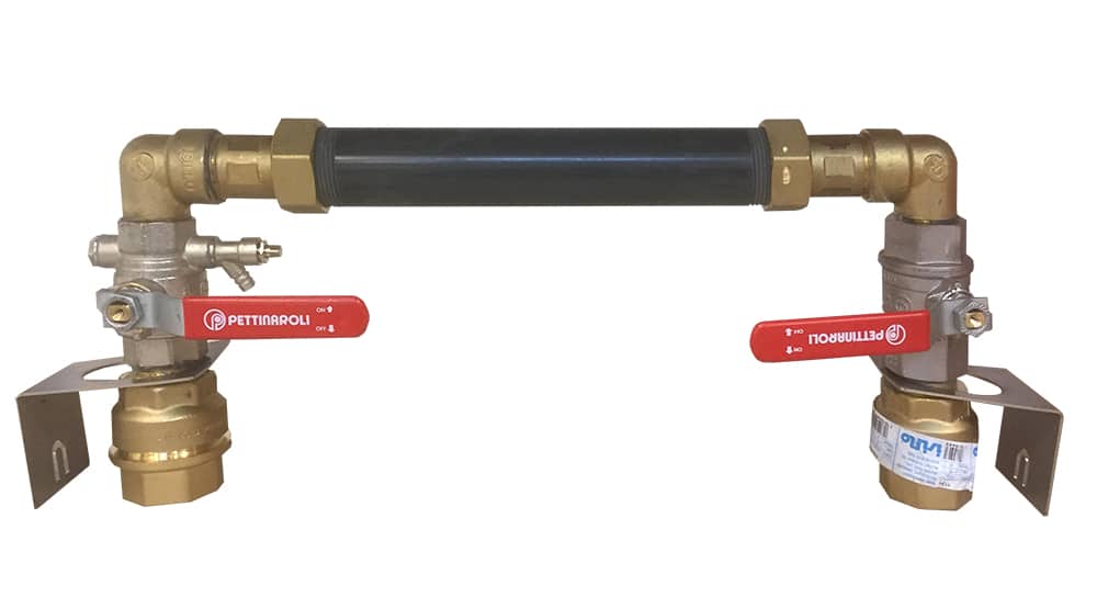 Brass pipe assembly with two red lever valves connected by a black hose, mounted on metal brackets at each end.