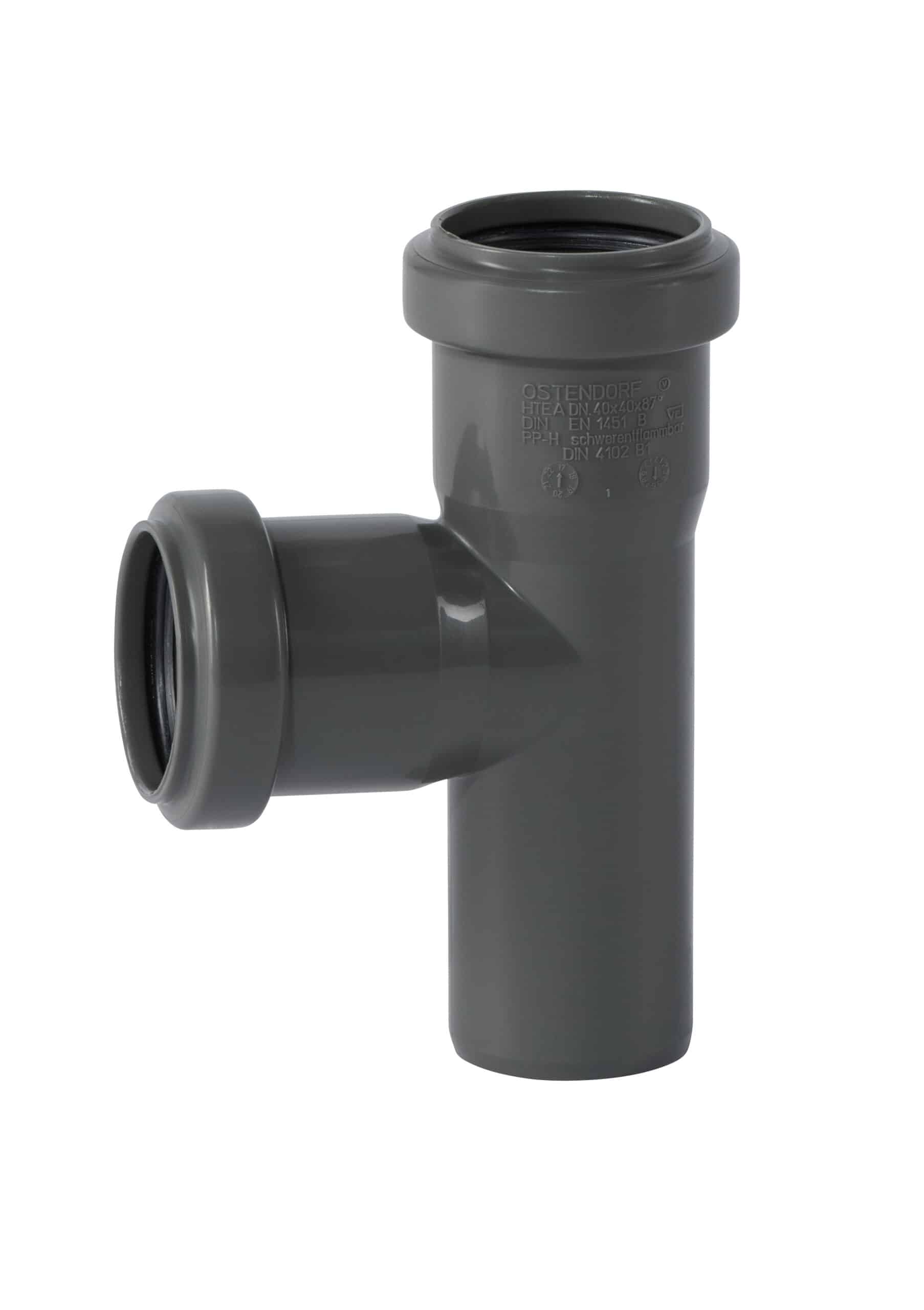 Gray plastic plumbing T-junction (tee) connector with side outlet, close-up view on white background, used for drainage lines