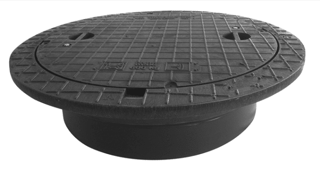 Round metal manhole cover with a textured grid, resting on a cylindrical base, viewed from the side.